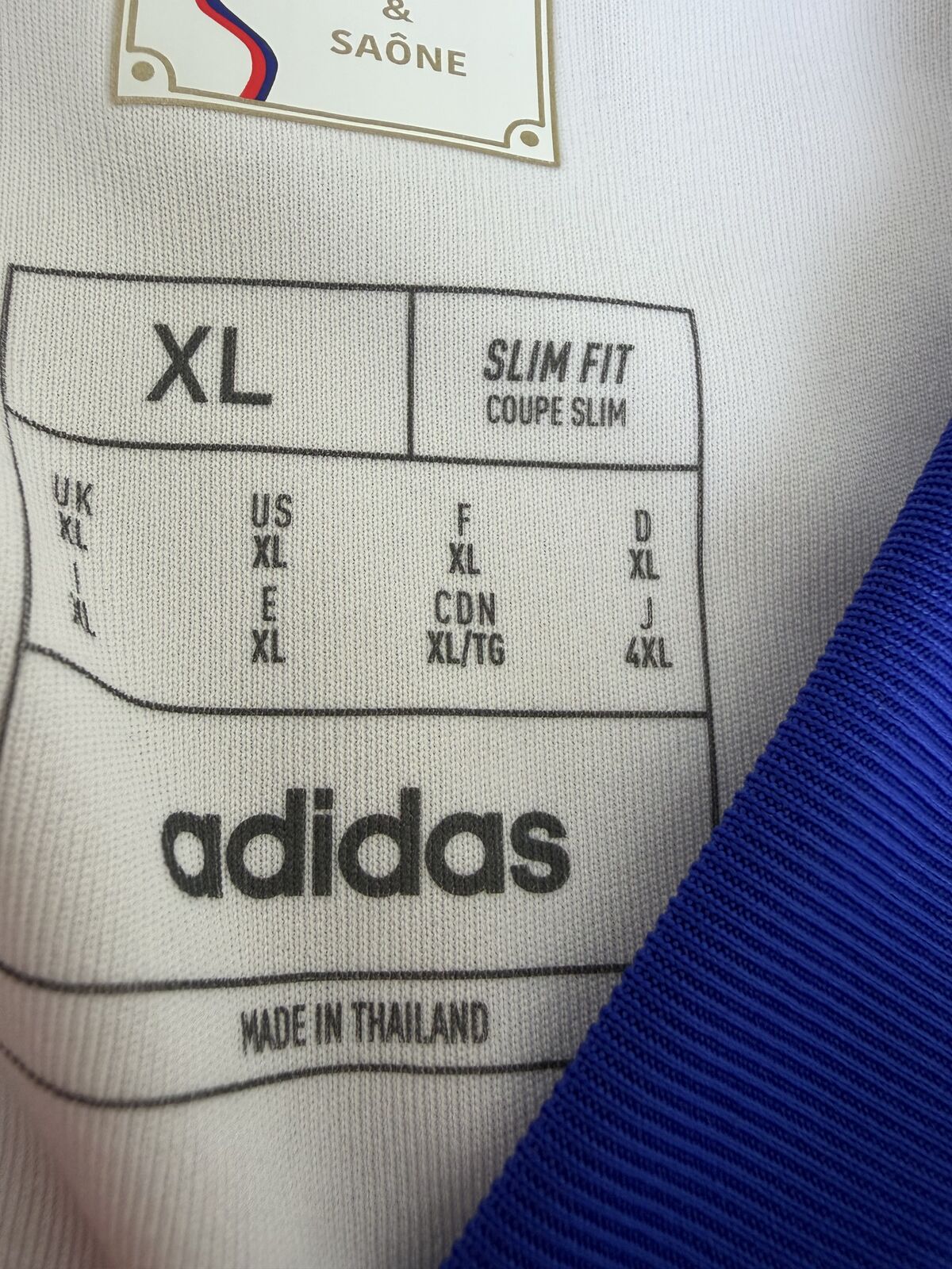 Printed interior size label reading XL, SLIM FIT / COUPE SLIM, with international size conversions, the adidas wordmark and MADE IN THAILAND