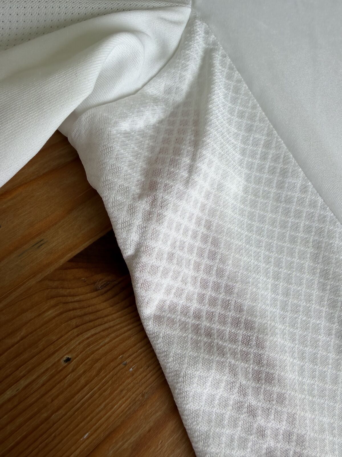 Close-up of the textured jacquard side panel fabric beside the smooth main body fabric