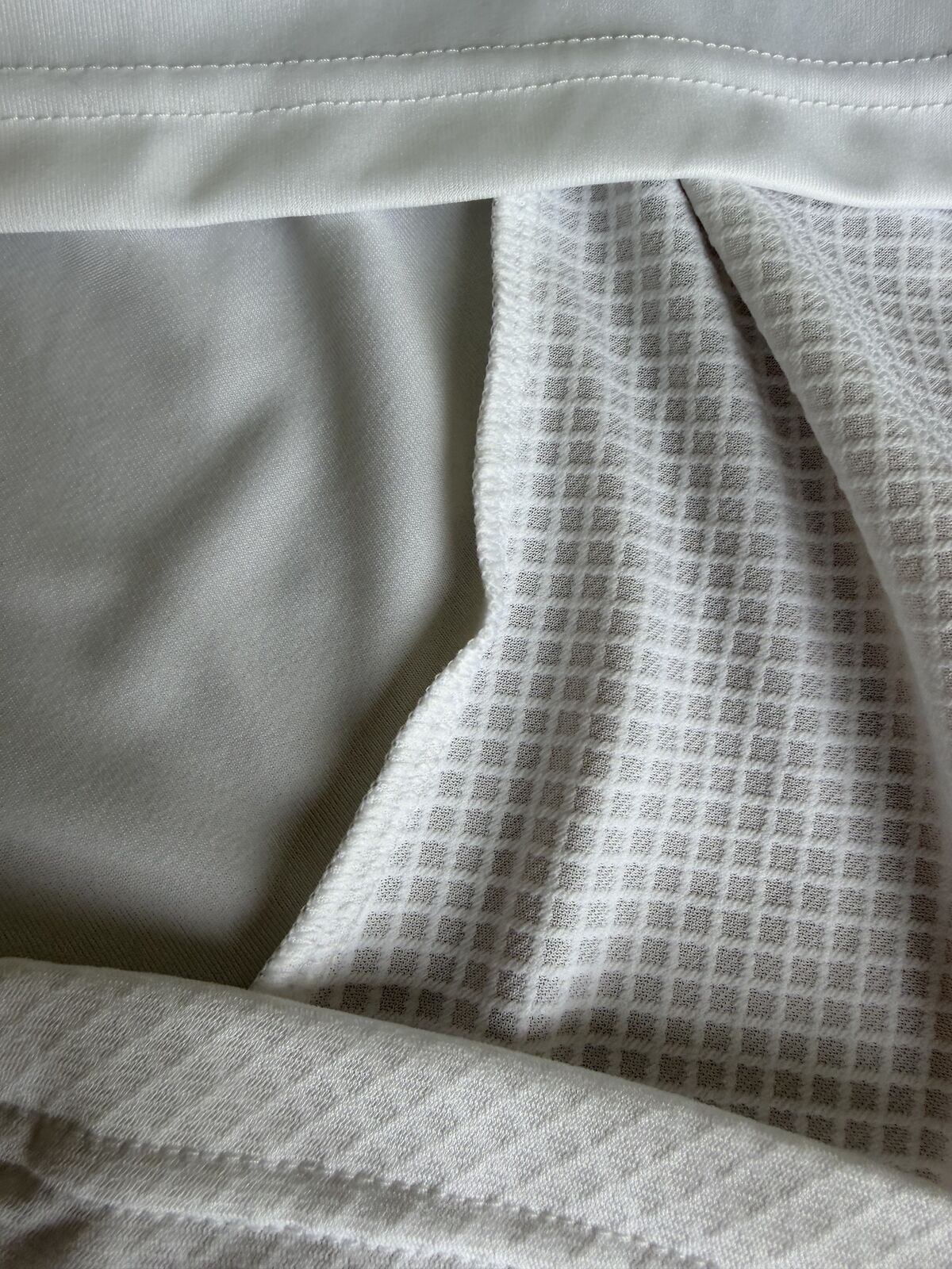 Interior view showing the hem, overlocked seam and the reverse face of the jacquard panel