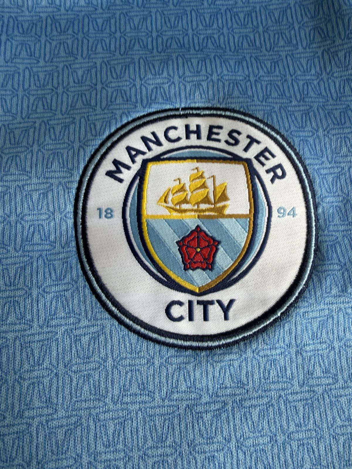 Close-up of the embroidered Manchester City crest