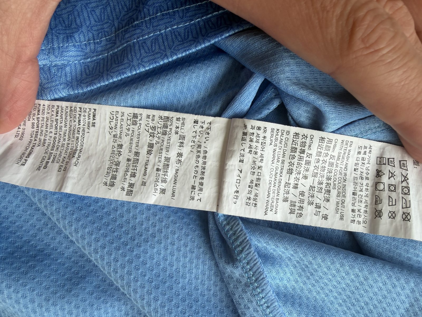 Fabric composition and wash-care label showing polyester and elastane percentages