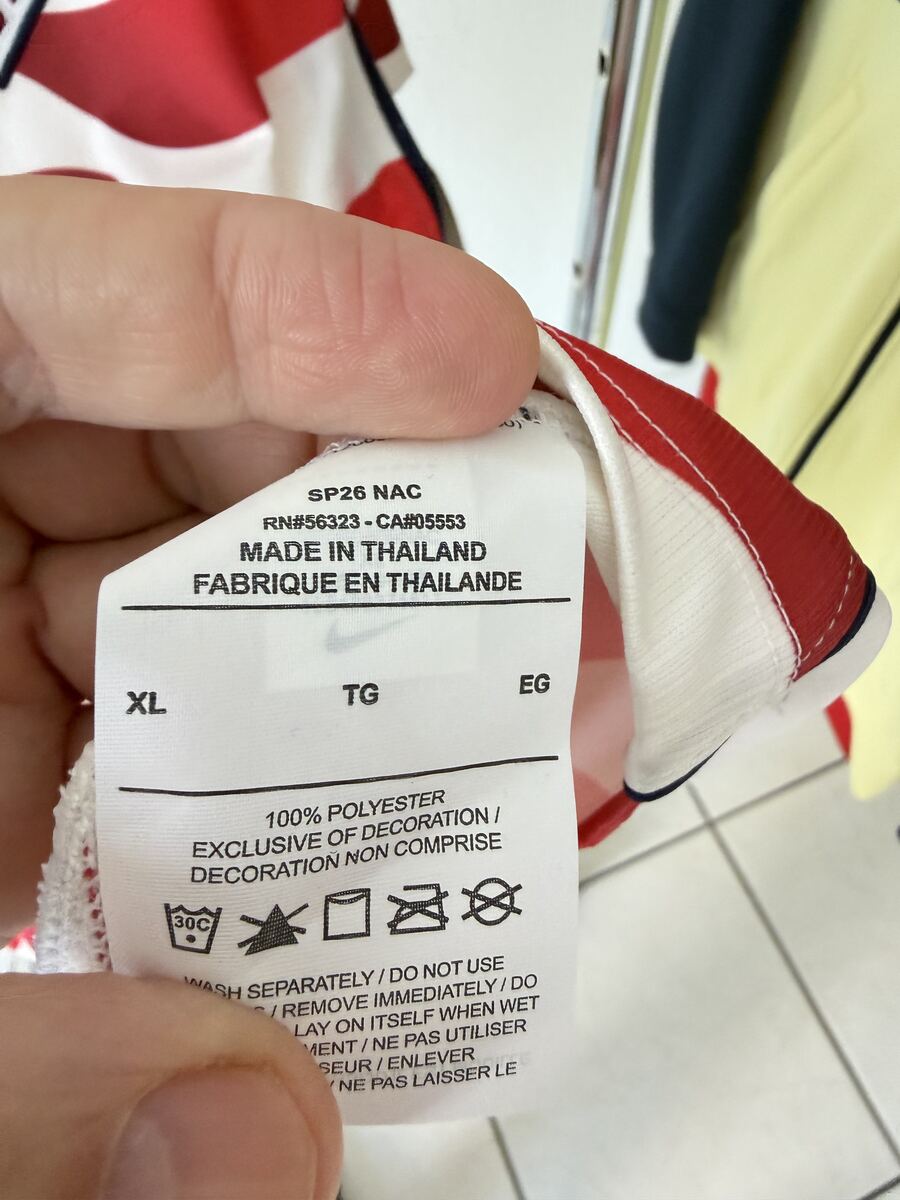 Genuine Nike care label showing RN#56323, CA#05553, Made in Thailand, fabric content, and wash symbols