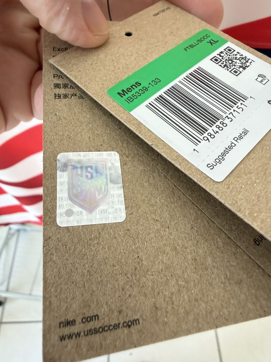 Genuine holographic authenticity sticker with USA shield logo next to the hangtag barcode